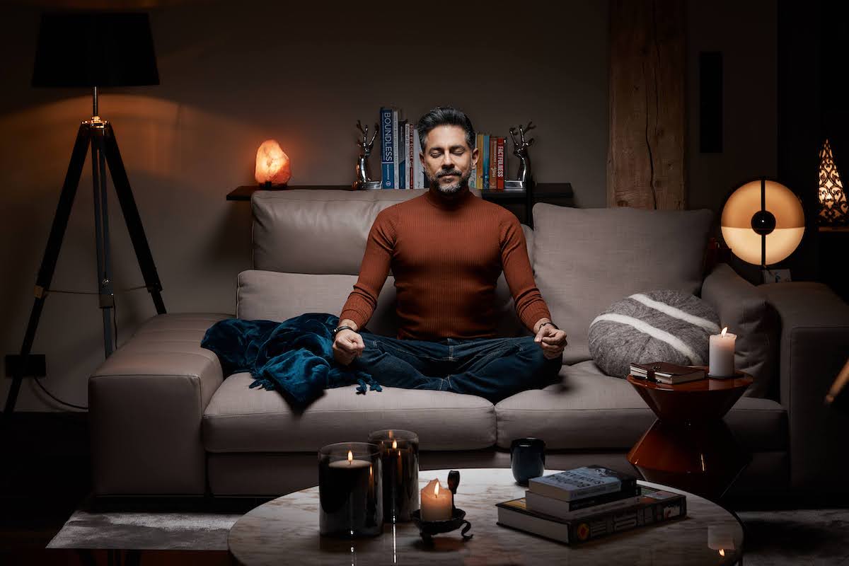 Vishen, founder of Mindvalley, sitting on a coach and doing the 6 Phase Meditation