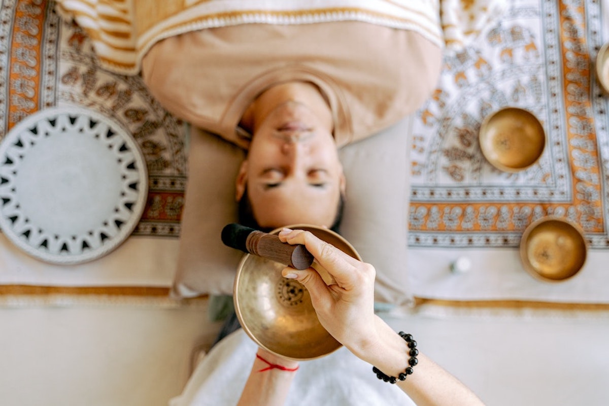 Man laying on his back during a sound bowl healing