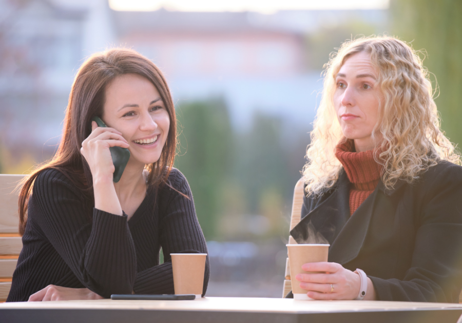 woman answering a phone in the middle of conversation signs your friend doesn't care about you