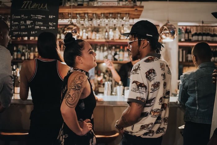 man and woman at bar talking how to make small talk
