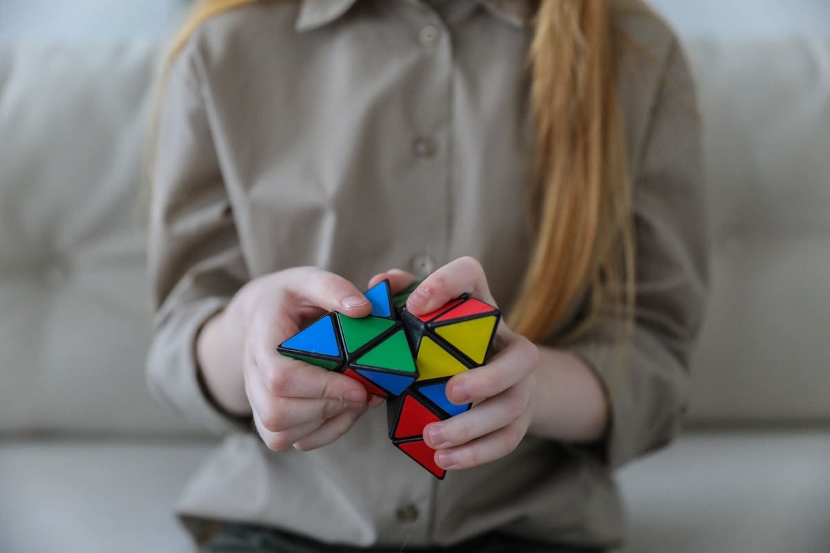 Girl using fluid reasoning to solve Rubik's cube