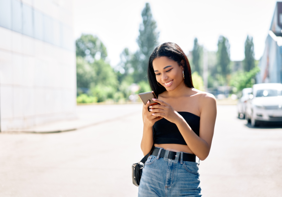 young woman happily texting how to not be a dry texter