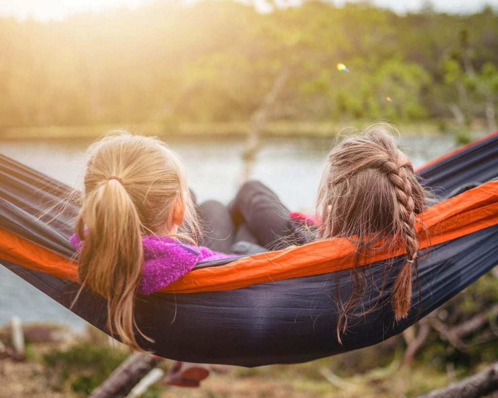 2 girls sitting in hammock relaxing things to do