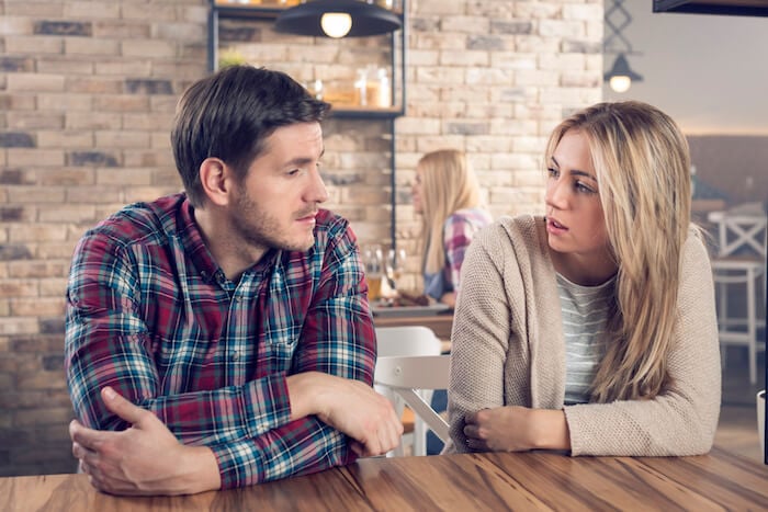 woman and man talking at table how to end a conversation