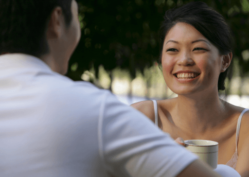 woman smiling sitting with man how to respond a compliment from a guy