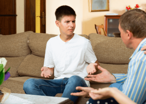 man talking to younger man on sofa letter to disrespectful son