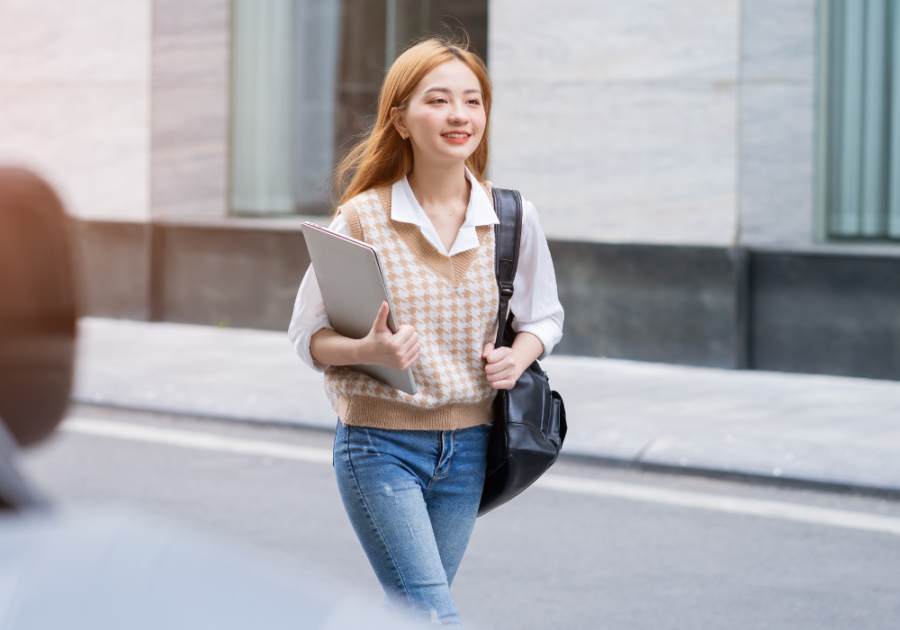 young woman walking in the street to work intentions for the day