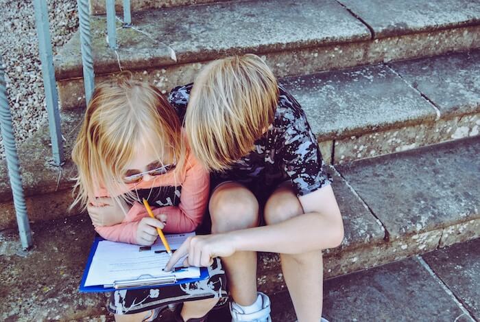 young students doing homework how to be a nicer person