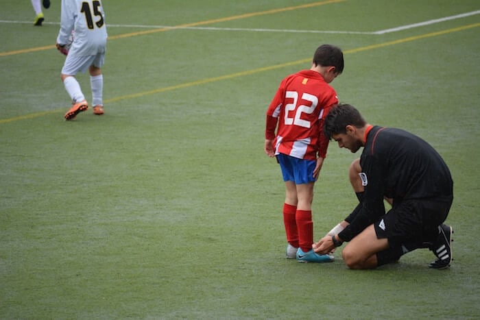 referee helping young player how to be a nicer person