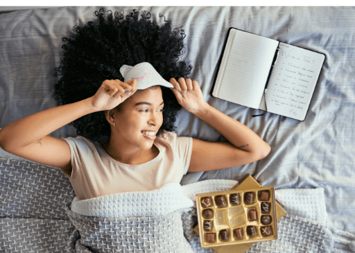 woman in bed with sweets how to pamper yourself 