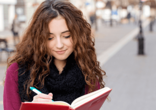 you woman writing in book outdoors Rare words with beautiful meanings