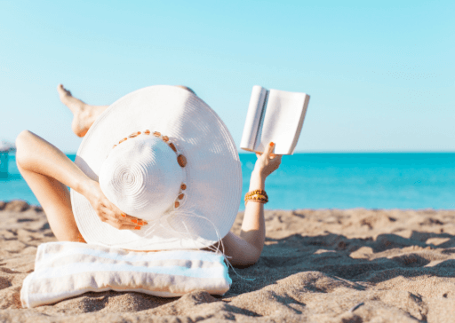 woman laying on beach reading Rare words with beautiful meanings