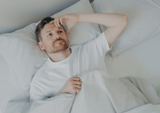 man laying in bed what to do when you can’t sleep and are bored